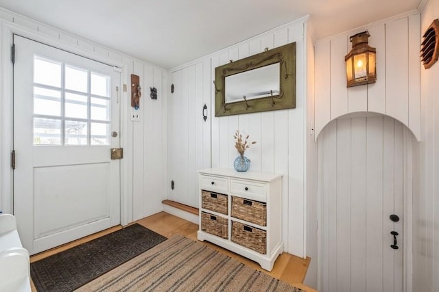 doorway featuring wood walls