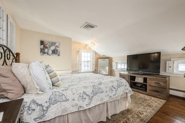 bedroom with vaulted ceiling, dark hardwood / wood-style floors, and a baseboard radiator