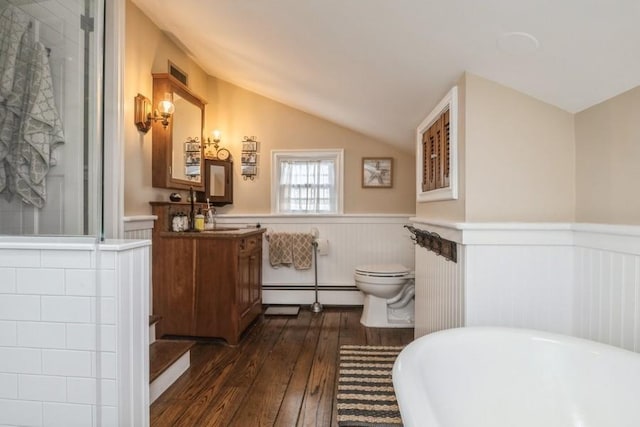 bathroom featuring toilet, a baseboard heating unit, vaulted ceiling, a bath, and hardwood / wood-style flooring