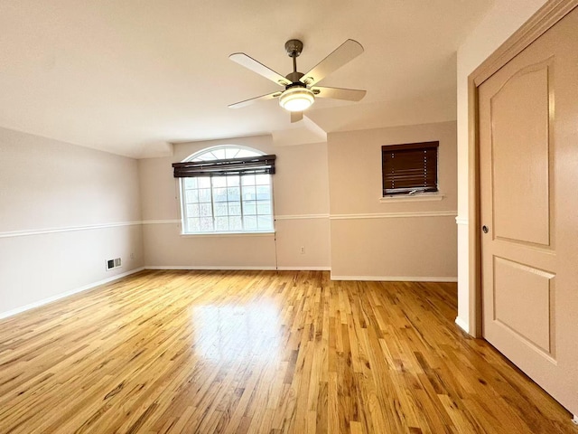 spare room featuring ceiling fan and light hardwood / wood-style flooring