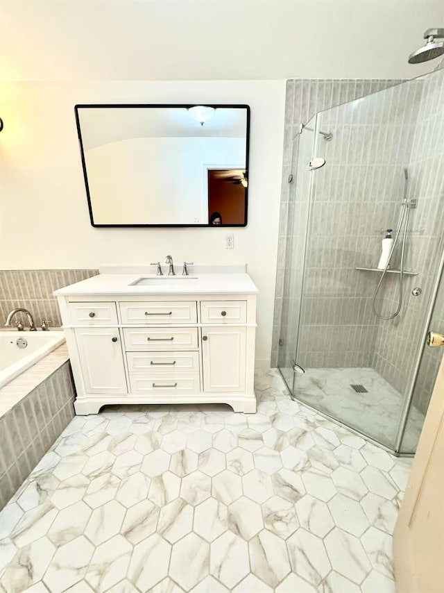 bathroom with independent shower and bath and vanity