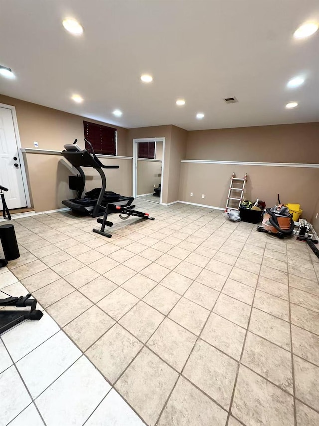 workout room featuring light tile patterned floors