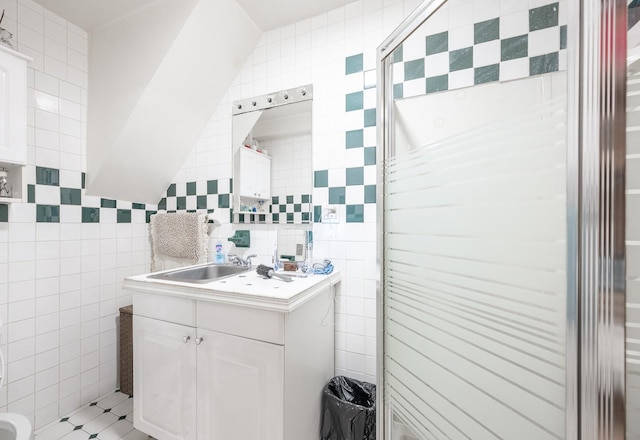 bathroom with tile walls and vanity