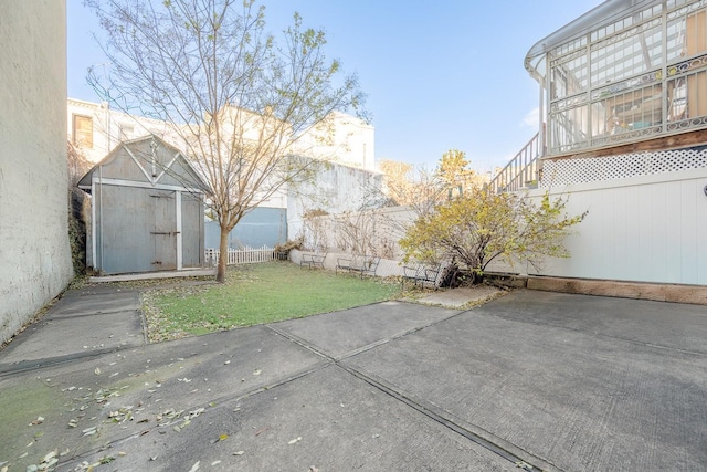 view of yard with a patio area and a storage shed