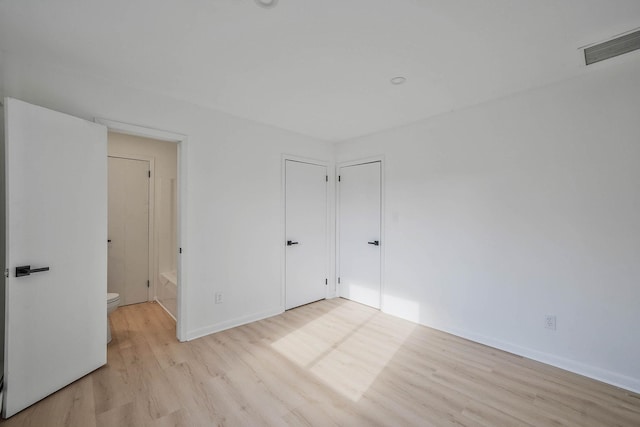 unfurnished room with light wood-type flooring