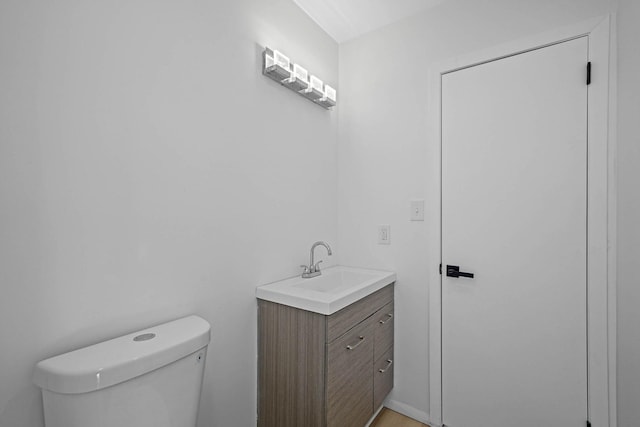 bathroom featuring toilet and vanity