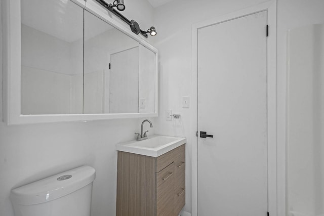 bathroom with toilet and vanity