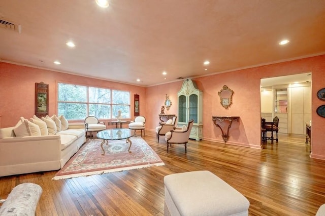 living room featuring light hardwood / wood-style flooring and ornamental molding