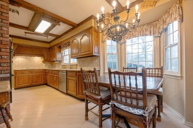 kitchen with tasteful backsplash, a notable chandelier, beamed ceiling, and dishwasher