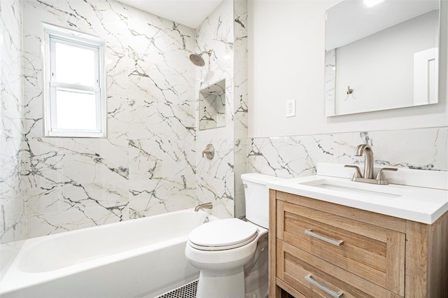 full bathroom with vanity, tiled shower / bath, tile walls, and toilet