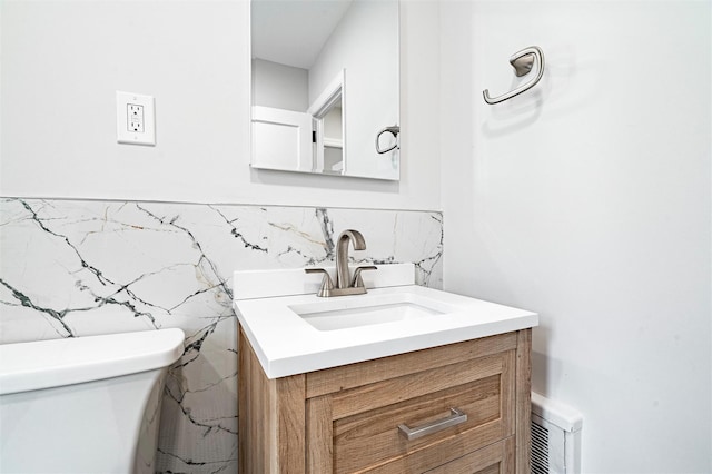 bathroom featuring vanity and toilet