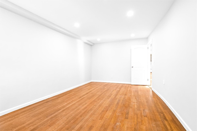 empty room with light hardwood / wood-style flooring