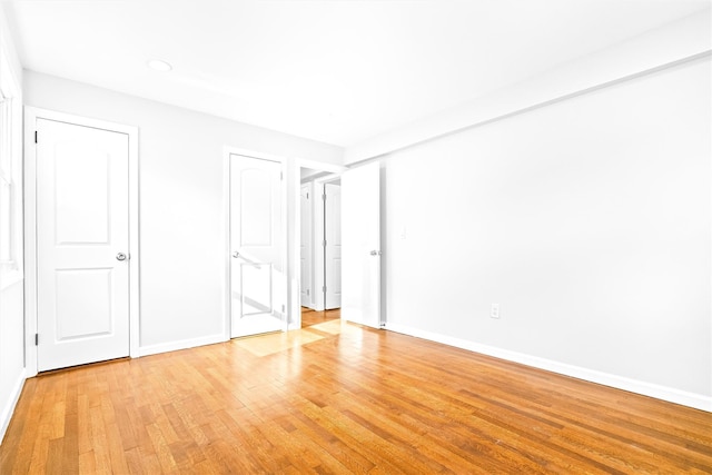 unfurnished bedroom featuring light wood-type flooring