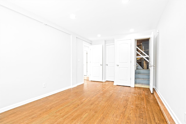 empty room with light hardwood / wood-style flooring