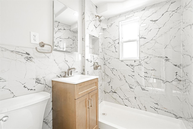 bathroom featuring vanity, tile walls, toilet, and a shower