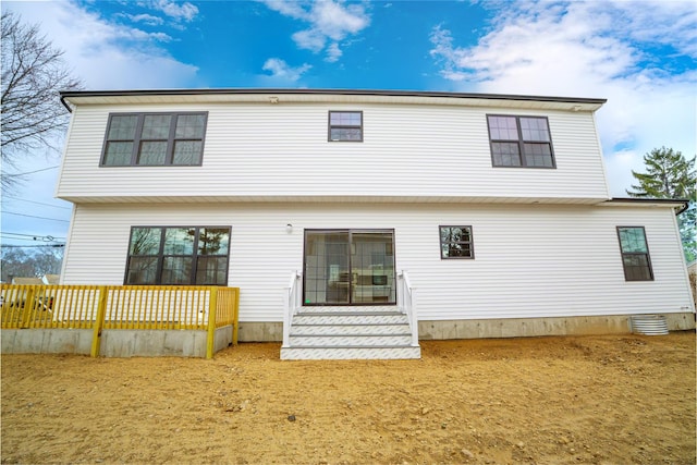 rear view of house featuring cooling unit and fence