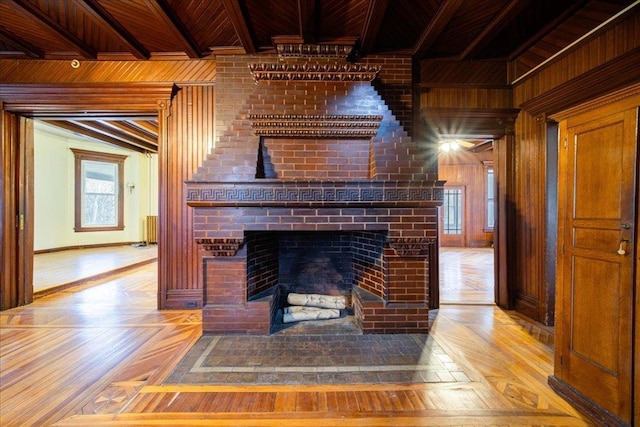 details featuring beamed ceiling, wooden walls, a fireplace, and wood ceiling