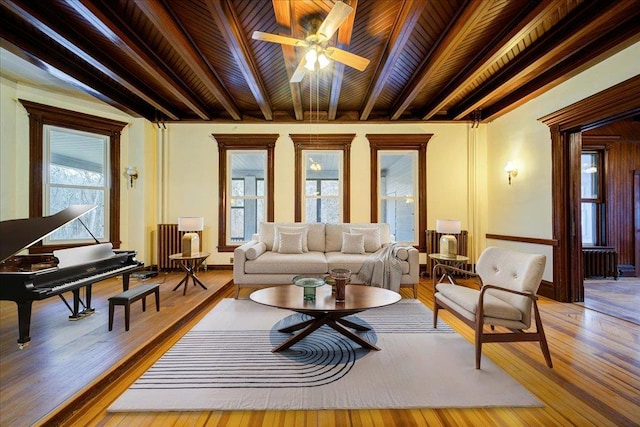 living room with wood ceiling, wood-type flooring, beamed ceiling, and a healthy amount of sunlight