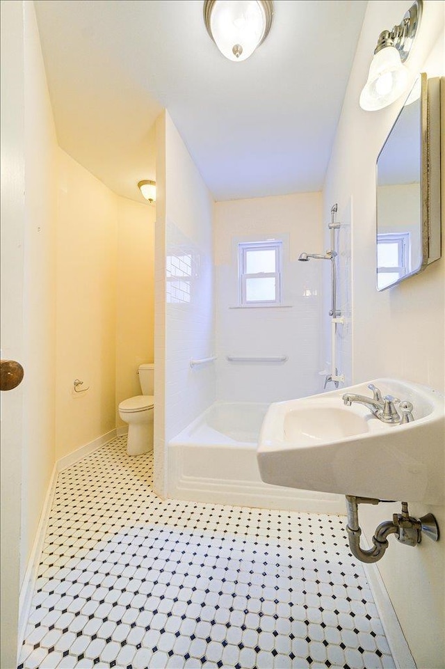 full bathroom featuring sink, washtub / shower combination, and toilet