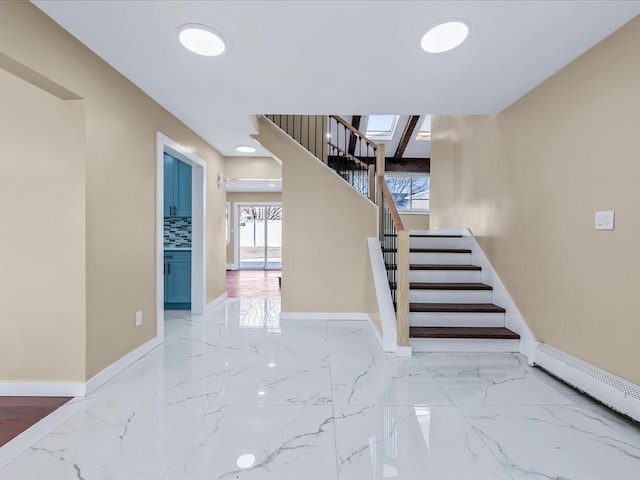 stairs featuring a baseboard radiator and beamed ceiling