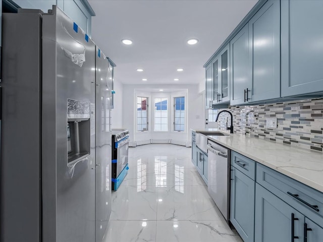 kitchen featuring sink, stainless steel appliances, light stone countertops, and decorative backsplash