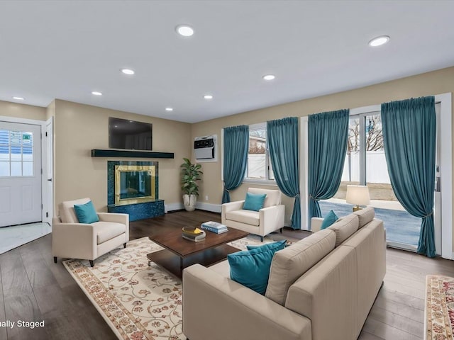 living room featuring hardwood / wood-style flooring and a wall mounted AC