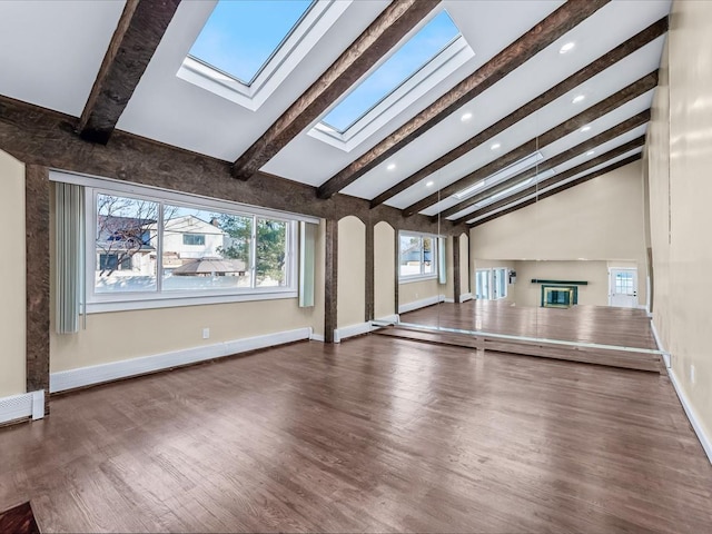 unfurnished living room with a baseboard radiator, vaulted ceiling with skylight, and dark hardwood / wood-style flooring