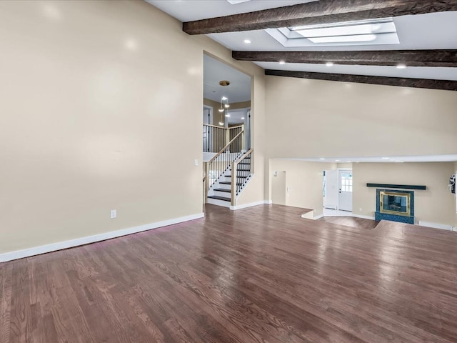 unfurnished living room featuring vaulted ceiling with beams and wood-type flooring