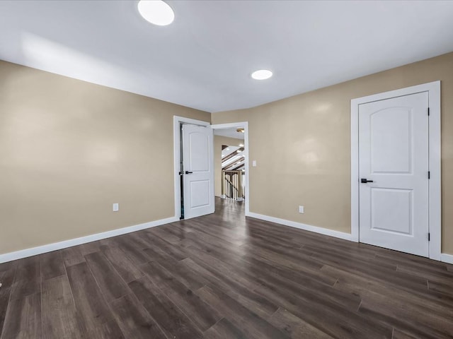 unfurnished bedroom with dark hardwood / wood-style flooring