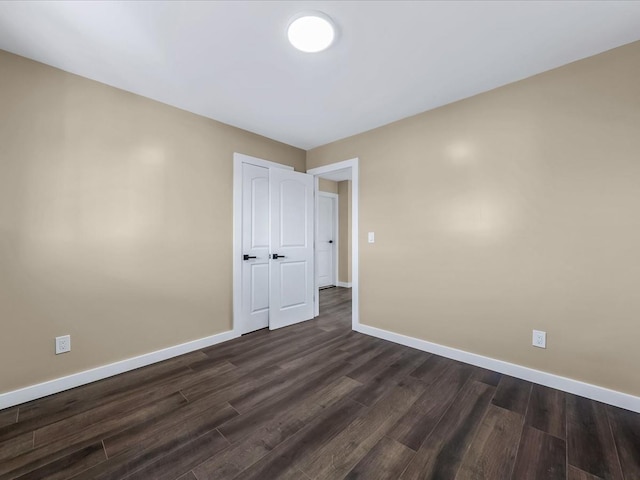 spare room featuring dark wood-type flooring