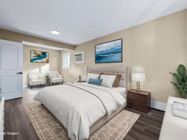 bedroom featuring a wall mounted AC and dark hardwood / wood-style floors