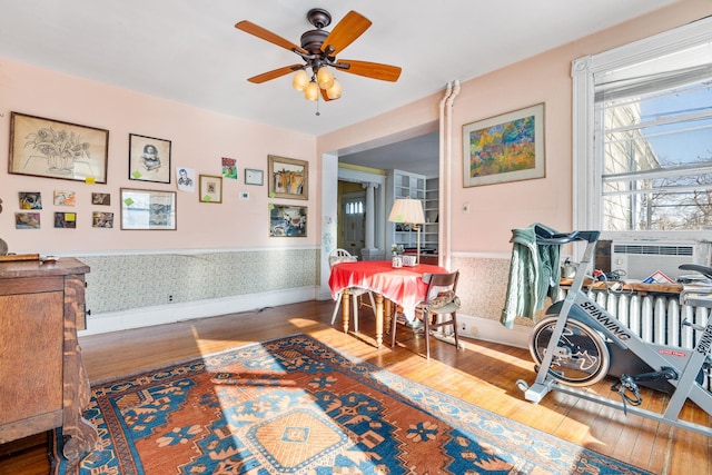 recreation room with cooling unit, hardwood / wood-style flooring, and ceiling fan