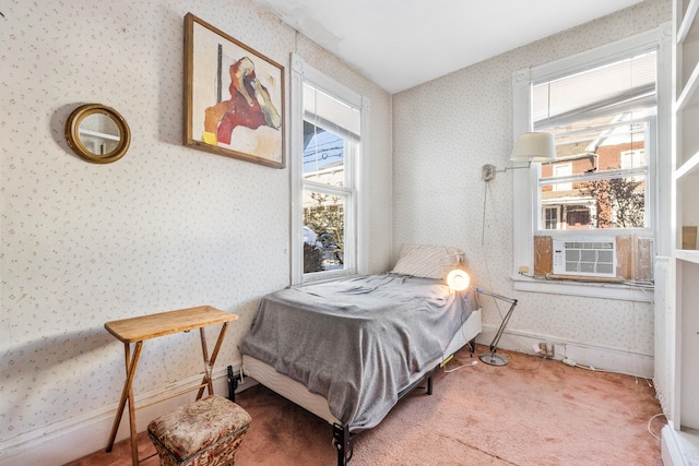 carpeted bedroom with cooling unit and multiple windows