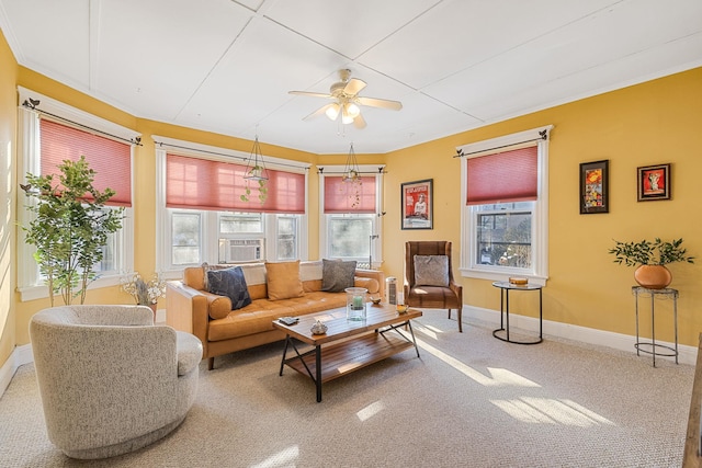 carpeted living room with ceiling fan and a wealth of natural light