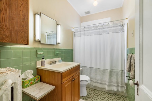 bathroom featuring vanity, tile walls, walk in shower, and toilet