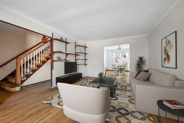 living room with ornamental molding and light wood-type flooring