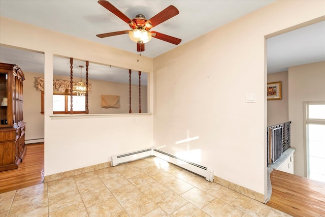 unfurnished room with a baseboard heating unit and ceiling fan