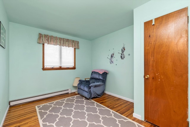 sitting room with hardwood / wood-style flooring and a baseboard radiator