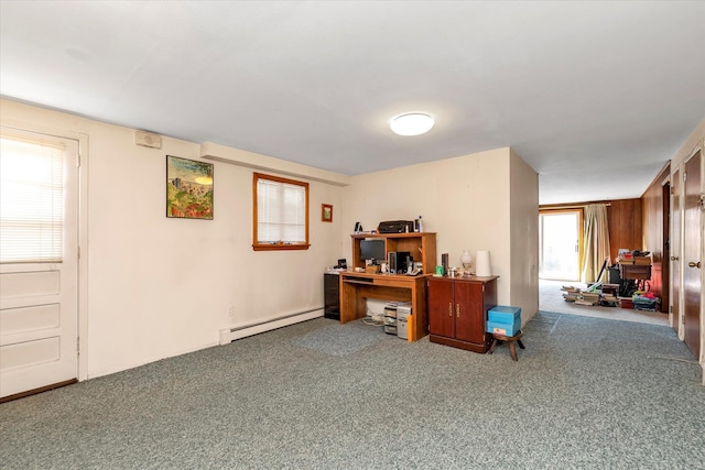 carpeted office space with wooden walls and baseboard heating