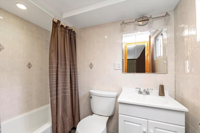 full bathroom with vanity, tile walls, shower / bathtub combination with curtain, and toilet