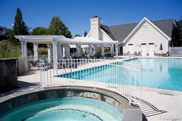 view of swimming pool featuring a hot tub, a patio, and a pergola