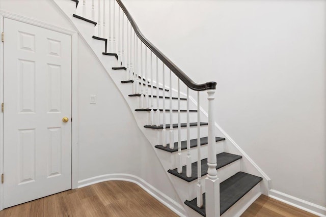 stairs featuring hardwood / wood-style flooring