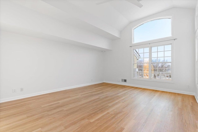 spare room with lofted ceiling and light hardwood / wood-style floors