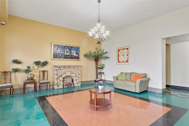 living room featuring a stone fireplace and a chandelier