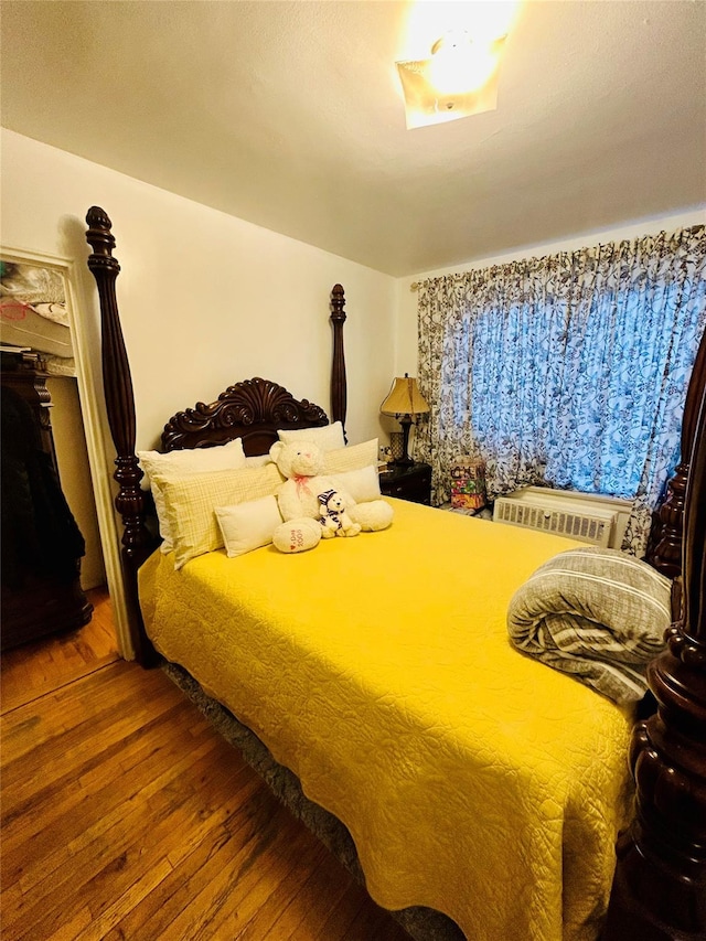 bedroom with hardwood / wood-style flooring