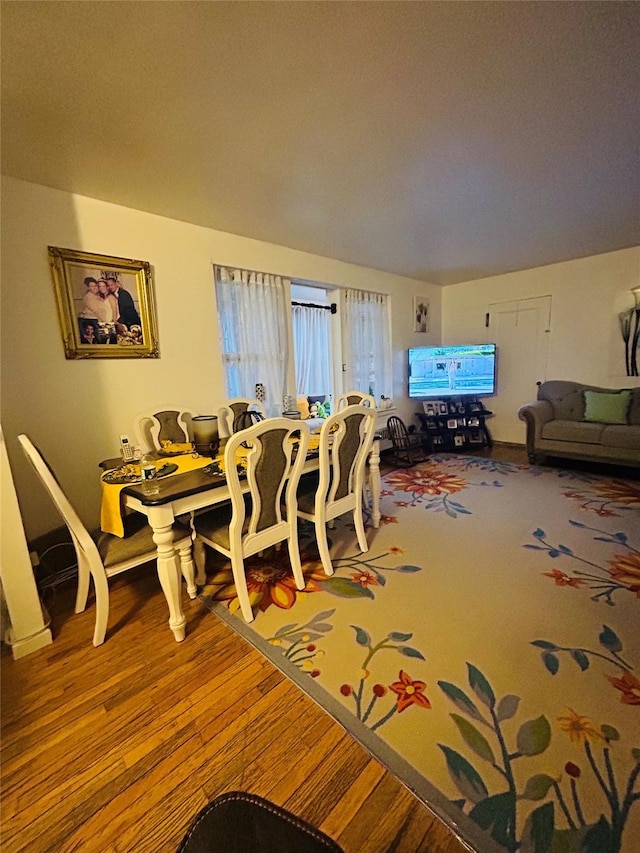 dining space featuring wood-type flooring