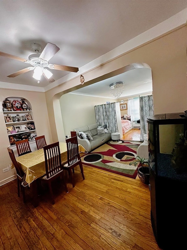 dining area featuring ceiling fan, hardwood / wood-style floors, and built in features