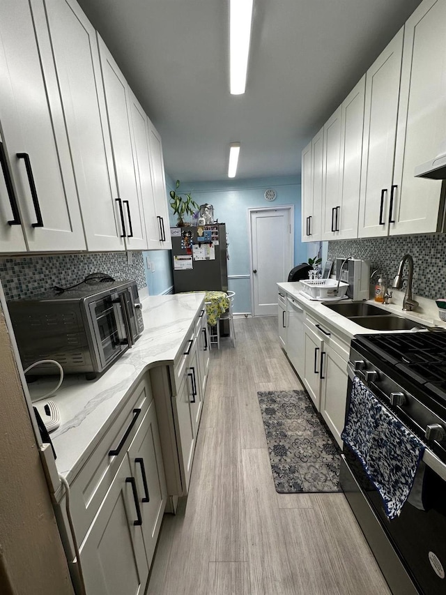 kitchen with white cabinets and appliances with stainless steel finishes