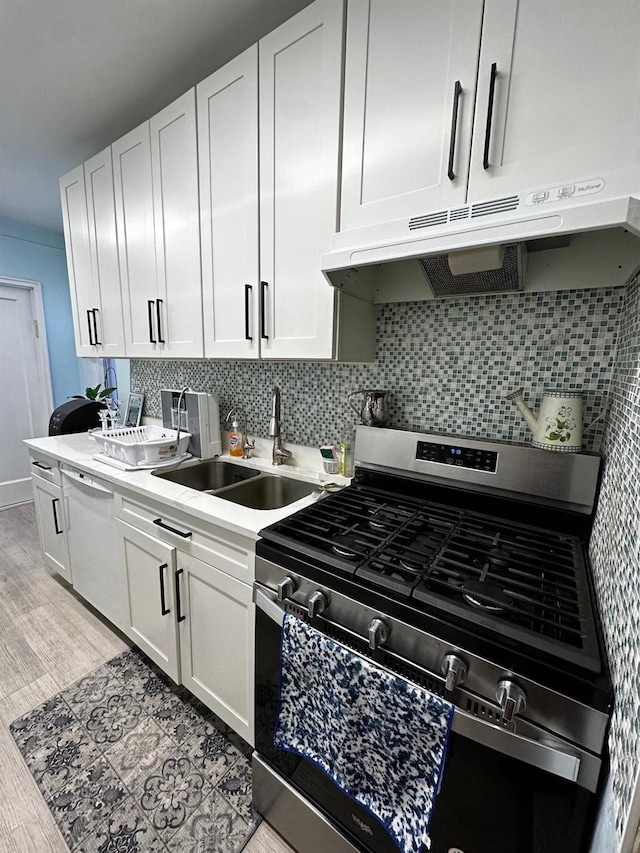 kitchen with backsplash, dishwasher, sink, white cabinetry, and stainless steel gas stove