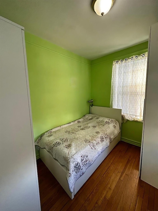 bedroom with dark hardwood / wood-style floors